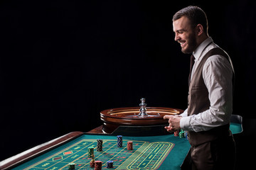 Croupier behind gambling table in a casino.