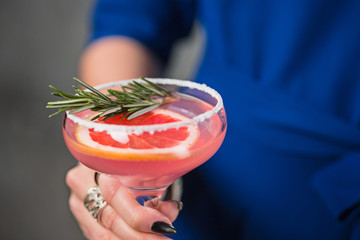 The exotic cocktail and female hands