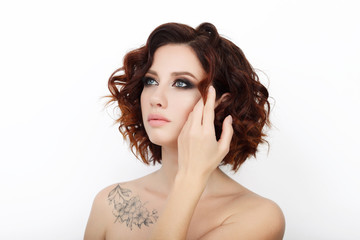 Close up beauty studio shot of beautiful redhead woman with gorgeous makeup curly hair