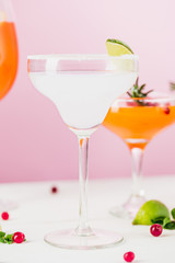 The rose exotic cocktails and fruits on pink
