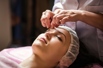 Fototapeta na wymiar calm girl having spa facial massage in luxurious beauty salon