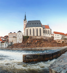 Fototapeta premium Church of St. Vitus on the banks of the Vltava in UNESCO Cesky Krumlov town