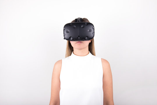 attractive, blonde, young woman wearing virtual reality headset
