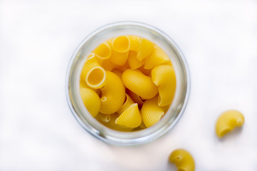 Italian type of pasta called pipe rigate in a glass container