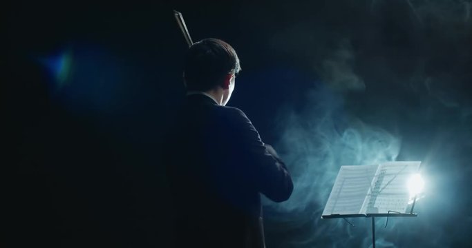 Asian violinist soloist male performing at a concert of classical music
