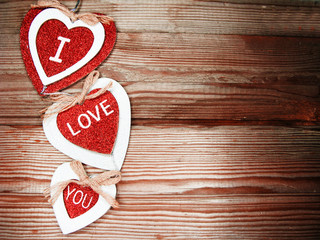 Obraz na płótnie Canvas valentine's day love holiday concept hearts on old wooden background