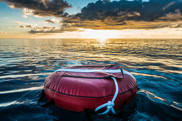 Red buoy for freediving floating in the ocean.