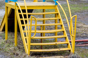 The yellow ladder for lifting on a children's slide