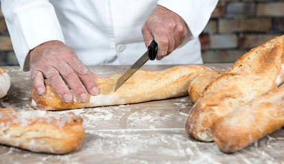 baker with traditional bread french baguettes