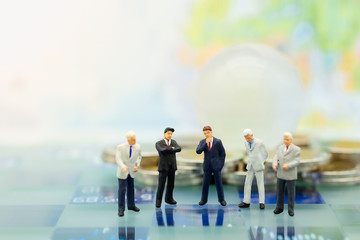 Miniature people, Group Businessmen standing on the chess game, thinking solution for the business game,  use as a business competition concept.