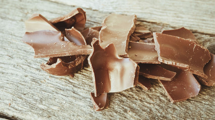 Crushed dark chocolate on old wooden table