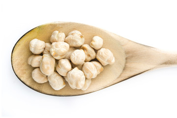 Chickpeas uncooked on wooden spoon isolated on white background