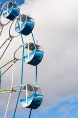 Children's carousel Ferris wheel with cabins in the Park