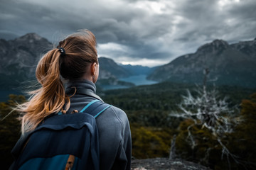 Woman hiker enjoys mountains view during bad weather. Patagonia, Argentina - obrazy, fototapety, plakaty