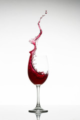 red wine splashing out of a Glass