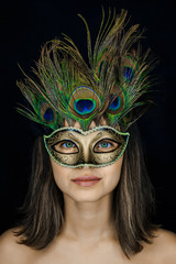 Close-up portrait of a young beautiful woman in a Venetian masquerade mask