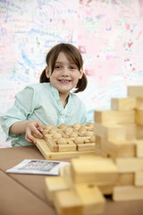 Girl   collecting   wooden puzzle