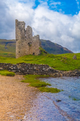 Ardvreck Castle, a ruined 16th century castle standing on a rocky promontory jutting out into Loch...