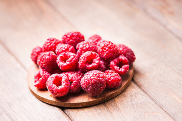 Raspberries on a wooden cutting board 