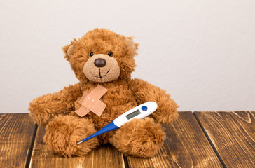 bear with a plaster and thermometer