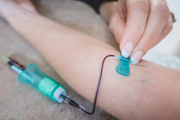 Medical technologist doing a blood draw services for patient.