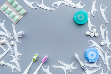 Tools for oral cavity hygiene. Brush, floss, gum on blue background copy space