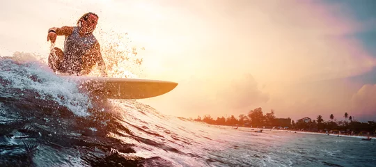 Foto op Plexiglas Surfer rides the ocean wave during sunset. Extreme sport and active lifestyle concept © Dudarev Mikhail