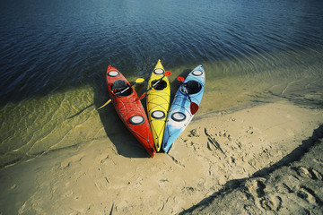 Kayaking on the Lake Concept Photo. Sport Kayak on the Rocky Lake Shore. Close Up Photo.