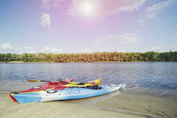Fototapeta na wymiar Kayaking on the Lake Concept Photo. Sport Kayak on the Rocky Lake Shore. Close Up Photo.
