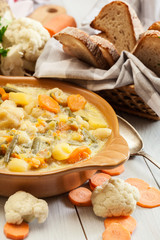 Vegetable soup with ingredients carrot, cauliflower, potato and parsley