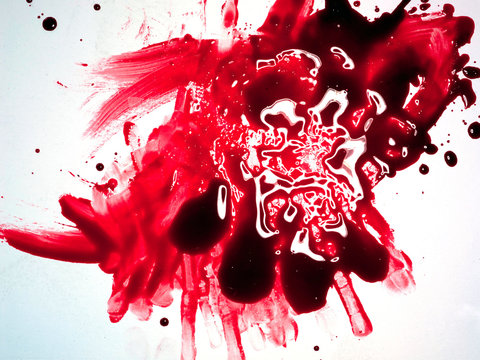 Red viscous fluid smeared on white background 