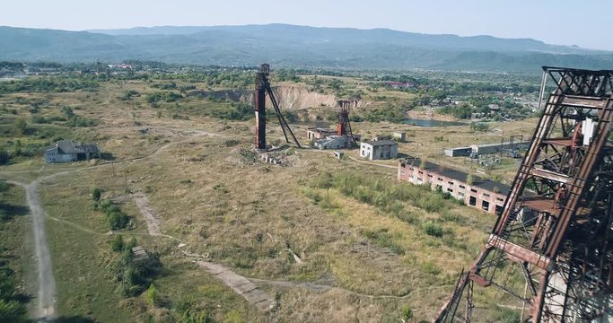 Aerial wiev: Fliying ower the two old abandoned Soviet union Salt mine against the background of Karst dips