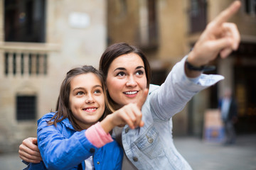 Young mother and daughter paying attention to sight