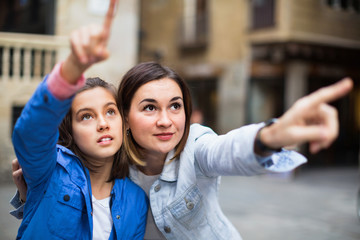 Young mother and daughter paying attention to sight