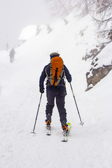 Man with skis walk by snow on the mountain