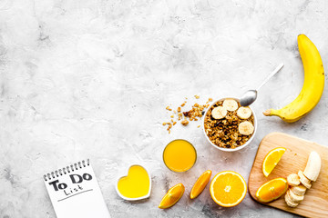 Start the day the right way. Healthy breakfast oatmeal with fruits and planning the day. Grey background top view copy space