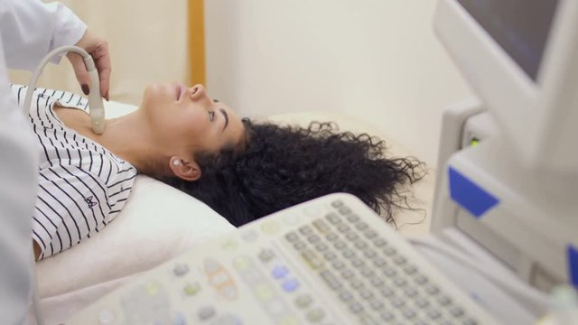 Doctor makes ultrasound test of thyroid and parathyroid