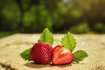 strawberries on natural background, delicious first class organic fruit as a concept of summer vitamins