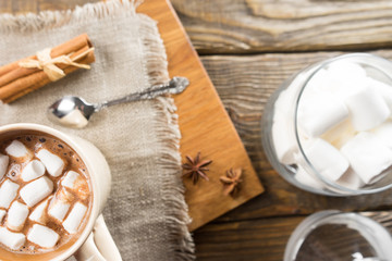 Hot Chocolate, Marshmallow and cinnamon on rustic table