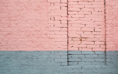 Pink and gray painted brick wall with a permanently closed door