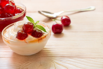 A bowl of greek yogurt with sugared cherry fruits, copy space.