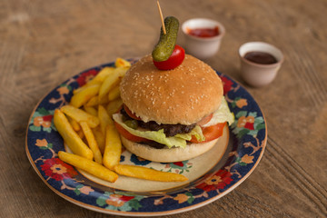 hamburger with french fries in plate with ornaments
