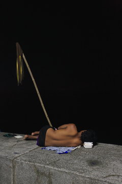 Homeless youngman to sleep on the Baywalk seawall. Malate-Manila-Philippines. 0045