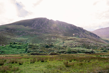 Fototapeta premium GAP OF DUNLOE, IRELAND - JUL 27, 2017: The Gap of Dunloe is a narrow mountain pass forged between the MacGillycuddy Reeks and Purple Mountain by glacial flows.