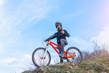 Fototapeta na wymiar Cyclist holding a mountain bike on top of the free space.