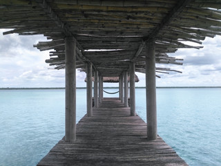 Wooden palapa pier made of bamboo and view to lagoon