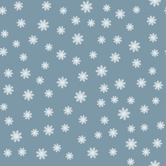 White snowflakes on a blue background. Seamless pattern