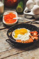 fried eggs with fried mushrooms and carrot salad