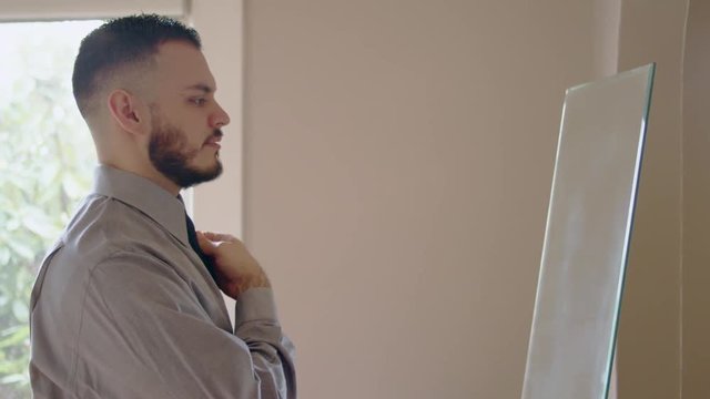 Young hispanic man practicing speech in front of mirror