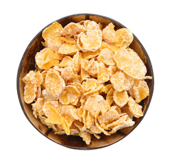 Closeup of delicious cereals in wooden bowl on a white background